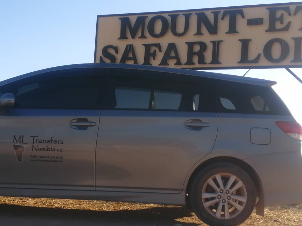 M·L Transfer car under the Mount Etjo Safari Lodge sign